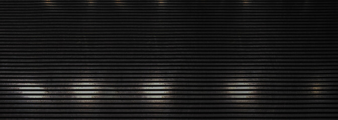 Dark industrial steel background featuring a repetitive horizontal slat pattern with subtle...