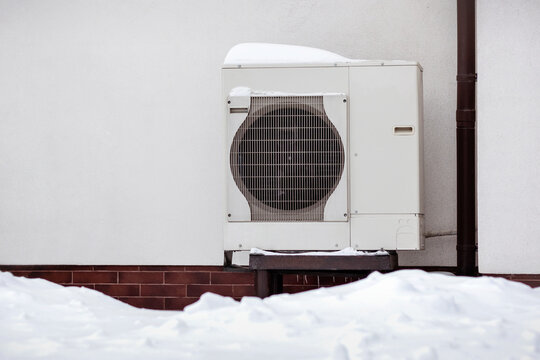 Heat Pump Home Radiator Heater Exchanger with Snow in Winter Background. Copy Space.