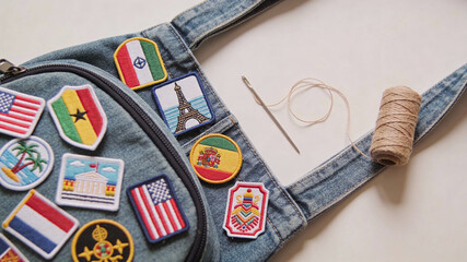 Travel patches and sewing supplies on a backpack ready for adventure and exploration