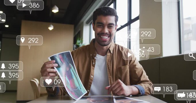 Animation of social media icons and numbers over businessman