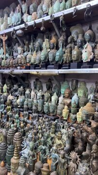CAMBODIA - October 2, 2025: Many different souvenirs at the street market in Siem Reap. Amulets at the old souvenir market "Psah Chas, Psar Chas, Psar Chaa". Buddha statues. Handicrafts. 4К