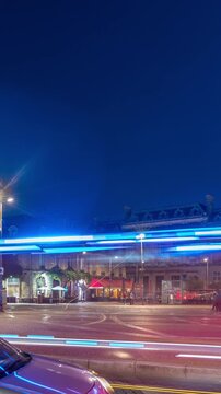 Porte d'Aquitaine arch and obelisk at Place de la Victoire day to night transition timelapse hyperlapse in Bordeaux, France. Landmark of historic Bordeaux with tram lines, cafes and lively surrounding