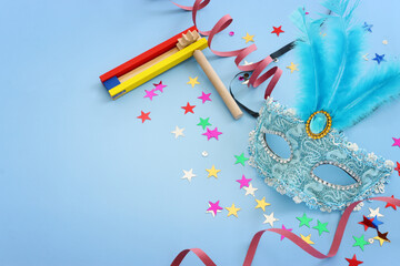 Purim celebration concept (jewish carnival holiday) over blue background