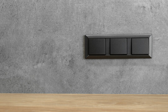Modern electrical anthracite power socket and plug switched waterproof with cover.