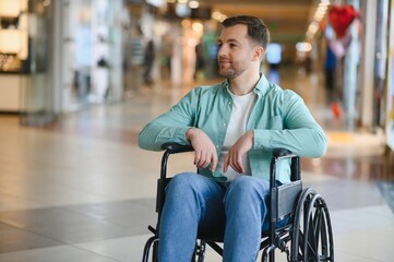 Smiling man in wheelchair enjoying shopping center visit