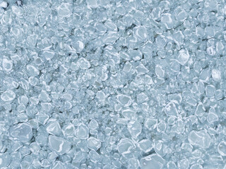 High angle aerial view of frozen pancake ice formations on the water surface creating a unique natural winter pattern texture. © Dmitri