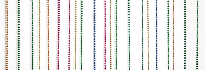 Colorful beaded curtain with vertical strands of red, orange, blue, green, and purple beads