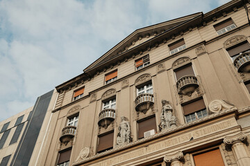 Obraz premium Historic building facade in Belgrade old town with sculptural details, balconies and classical ornaments, representing European cultural architecture and urban heritage.
