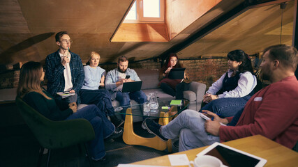 Diverse coworkers collaborating in modern open office space. Concept of inclusive teamwork, productive workflow, corporate culture for business and HR content.