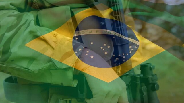 Animation of flag of brazil waving over soldier holding gun and walking in camp