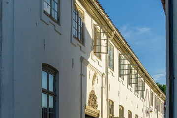 Obraz premium Historic White Stucco Facade in Son Norway with Open Casement Windows
