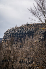 Obraz premium HRENSKO, CZECH REPUBLIC. 30th March 2025. Pravciska Brana valley with burned trees on mountains. The Pravciska brana is a narrow rock formation in Bohemian Switzerland in the Czech Republic.