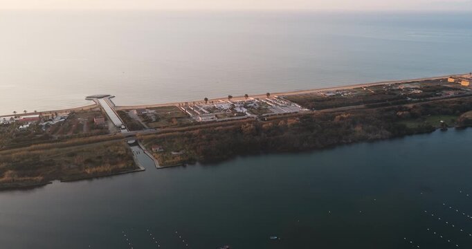 Aerial view of the tranquil Fusaro Lake, fringed by a thin strip of land between the lake and the sea, Fusaro Lake, Campania, Italy.