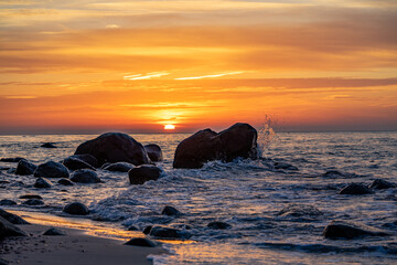 Pebble beach with rocks at sunset on the Baltic Sea island of R&uuml;gen