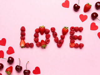 Sweet love berries and hearts on pink background. Top view
