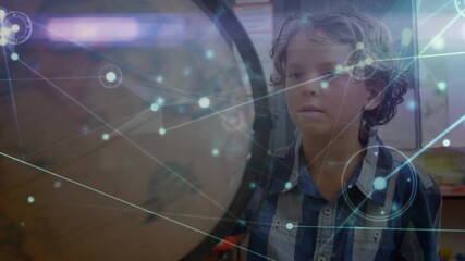 Animation of network of connections over caucasian schoolboy with globe - Powered by Adobe