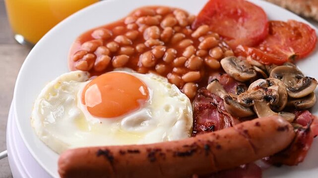 Rotating full English breakfast on wooden table