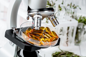 concept - check dietary supplements in laboratory on microscope
