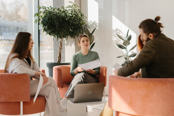 Business colleagues collaborating during a meeting in modern office lounge