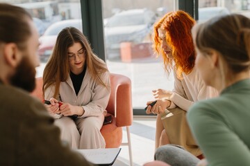 Business colleagues collaborating during a small group meeting