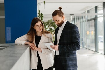 Business professionals discussing project details using tablet