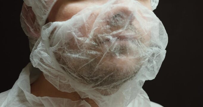 Close-up view of a person wearing a disposable beard cover, showing hygiene compliance and personal protective equipment in medical, laboratory, food, or industrial environments.