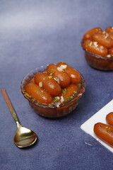 Lamba jamun is a traditional Indian sweet dessert made from milk solids, shaped into elongated...