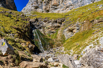 Walking on the Hunter's Trail, Senda de los Cazadores in autumn. Ordesa and Monte Perdido Natural Park, Pyrenees, Spain