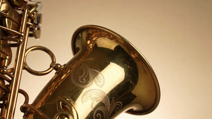 Close-up of engraved gold saxophone bell with brass keys
