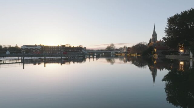 Marlow, UK Sunset flying over river towards bridge at sunset.