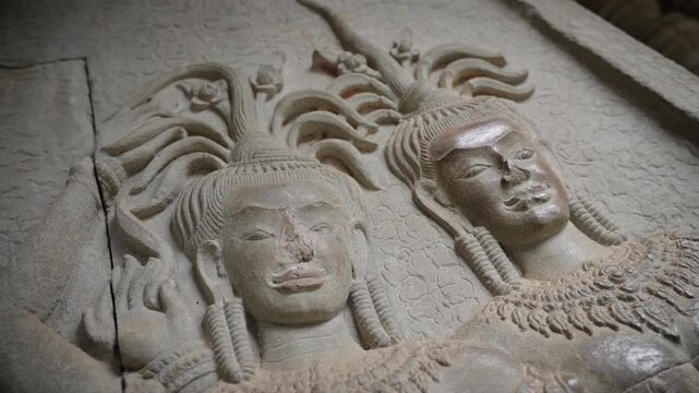 SIEM REAP, CAMBODIA - OCTOBER 27, 2025: Ancient Apsara Bas-Relief Carvings on Walls of Angkor Wat, Cambodia. Detailed 4K editorial footage  this UNESCO World Heritage Site.