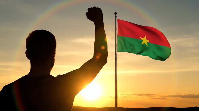 Man Celebrating with Burkina Faso Flag at Sunset