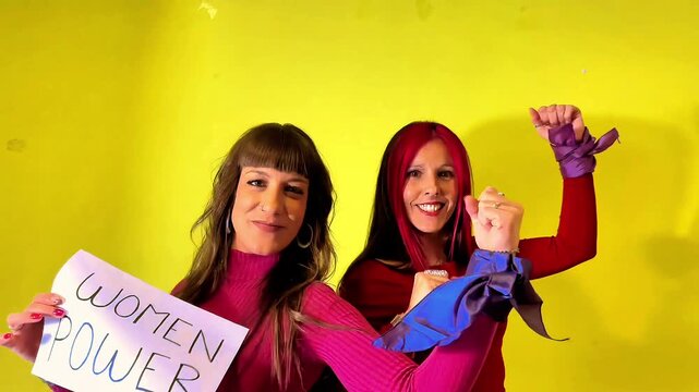 Women showing strength and power on yellow background