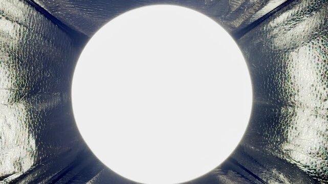 bright circular led light glowing inside reflective softbox tunnel creating abstract minimal background with copy space for wallpaper and commercial design