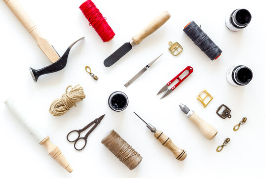 Leather craft work tools flat lay. Tailor or shoemaker on workplace, top view