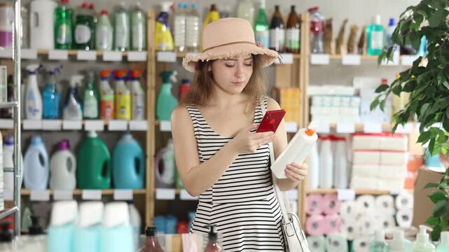 Girl buyer scans qr code on sun protection cream label, uses link to get additional information on Internet. Customer photographs product, searches for photo on Internet