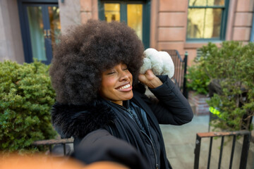 Stylish black woman enjoying winter selfie in new york city