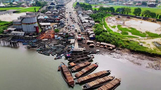 Aerial view of Rumuepirikom/Iwofe Road with moving cars and buildings, creating a vibrant urban scene, Port Harcourt, Rivers, Nigeria.