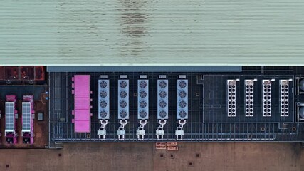 Close up aerial drone view of industrial data center exterior featuring high tech cooling fans ventilation systems and backup power generator units - Powered by Adobe