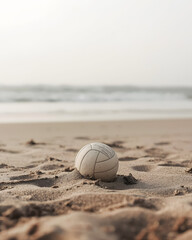 a volleyball resting on sandy beach