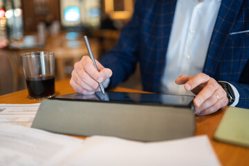 Businessman working on digital tablet during business trip