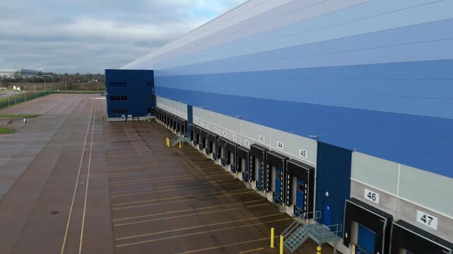 Close up aerial view of warehouse loading bays, doors for loading and unloading trucks and lorries, logistics and transport in Magna Park, United Kingdom