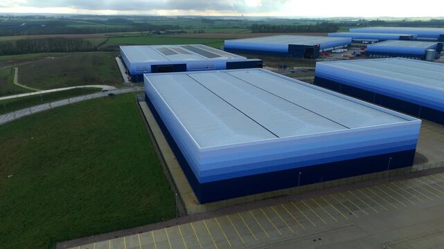 Aerial view of huge new build distribution centres, ombre cladding design, massive logistics and transport hub for import export manufacturing production businesses in Magna Park, UK 