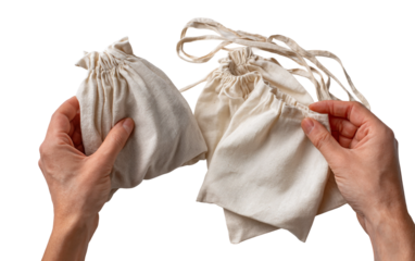 Detailed view of hands folding reusable bags promoting environmental responsibility and care isolated on transparent background PNG