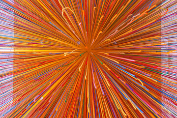 Abstract background of multi color threads hanging on the orange ceiling.