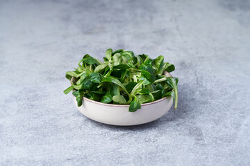 Bowl of fresh corn salad lamb's lettuce greens © EdienuFoto