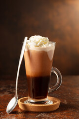 Fototapeta premium Hot chocolate with whipped cream in a glass mug.