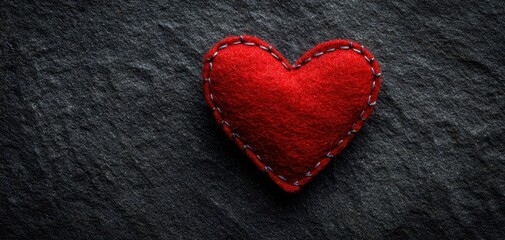 The Heart of Red Felt Stitched on Dark Slate Texture Evoking Warmth and Love