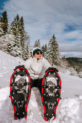Man in Snowshoes Taking Break in Snowy Landscape