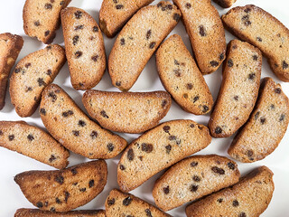 Breadcrumbs with sugar and raisins on a white background.